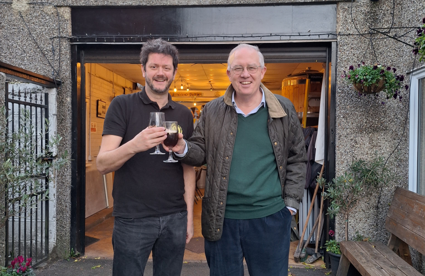 The photograph shows John with Alex Watson at the Brewery. 